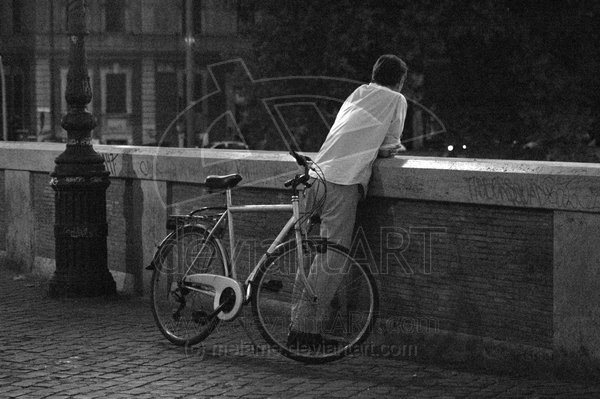 a bike, a bridge, a man